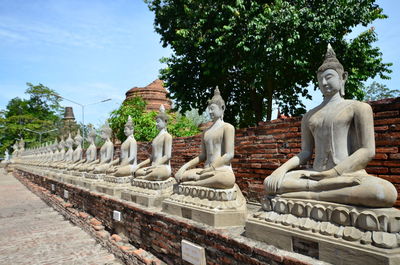 Statue against temple and building