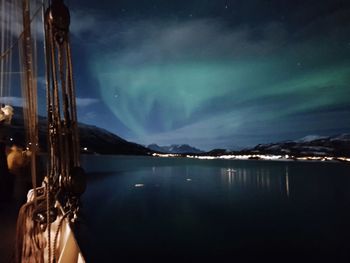 Scenic view of lake against sky at night