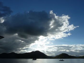 Scenic view of mountains against cloudy sky