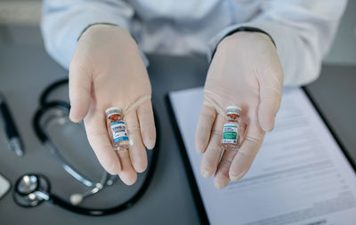Cropped hands of doctor holding medicines