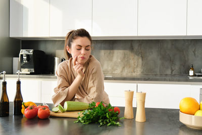 Portrait of young woman sitting at home