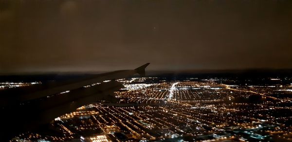 Aerial view of illuminated buildings in city at night