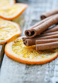 Close up of cinnamon over orange slices