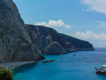 Scenic view of sea and mountains against sky