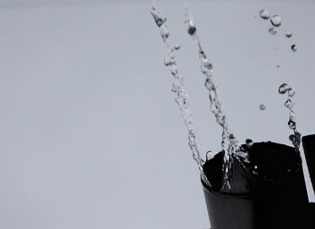 Close-up of water splashing against white background