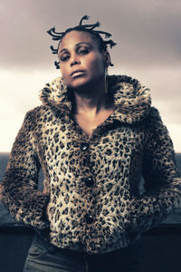 Portrait of young woman standing in snow