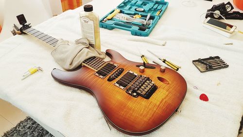 High angle view of guitar on table at home