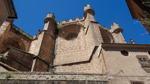 Low angle view of historic building against clear blue sky