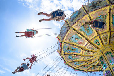 Low angle view of people at amusement park