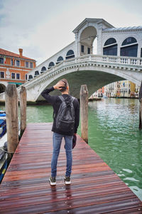 Full length of man standing on footbridge