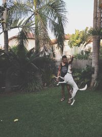 Boy playing with palm tree