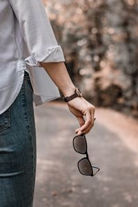 Midsection of man holding woman standing outdoors