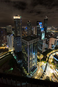 High angle view of illuminated street amidst buildings in city