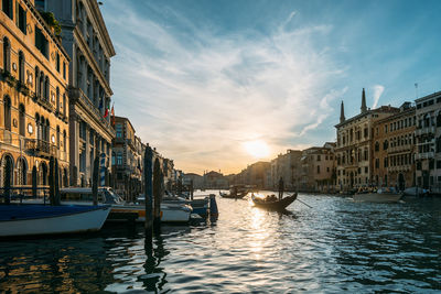 Boats in canal against sky