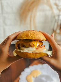 Close-up of hand holding burger