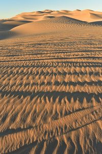 Scenic view of desert against sky during sunset