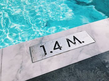 High angle view of text by swimming pool