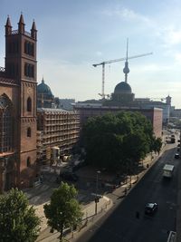 Buildings in city against cloudy sky