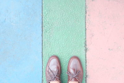 Low section of man standing on footpath