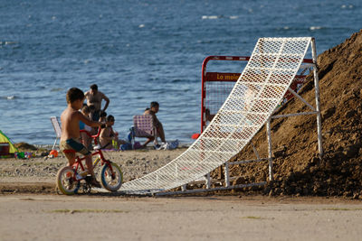 People riding bicycles on beach
