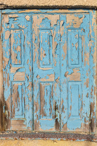 Weathered closed door of old house