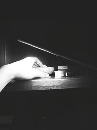 Person holding umbrella on table at home