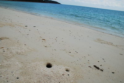 High angle view of footprints on beach