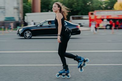 Portrait of young woman on road