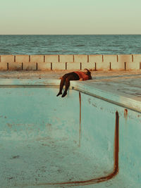 Young woman lying at poolside