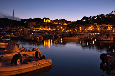 Boats in harbor at night