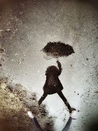 Reflection of woman in puddle