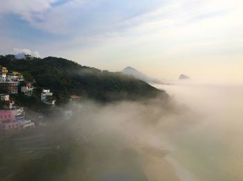 Scenic view of mountains and buildings against sky