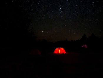 Illuminated light against sky at night