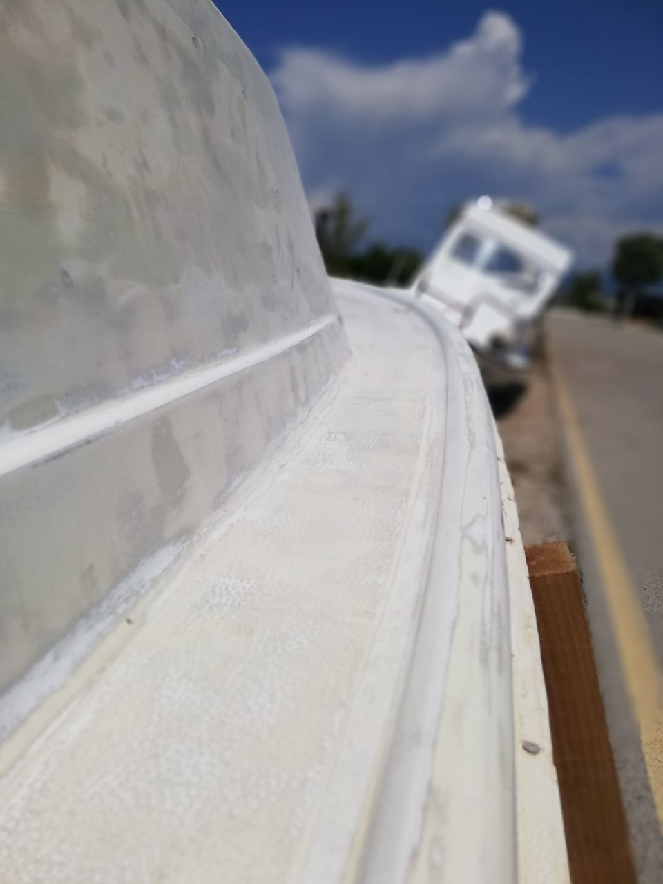 CLOSE-UP OF CAR MOVING ON ROAD