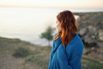 Woman standing against sea shore