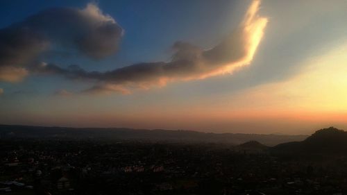 Scenic view of silhouette mountains against sky at sunset