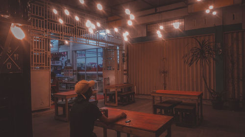 Man and woman standing on illuminated table at night