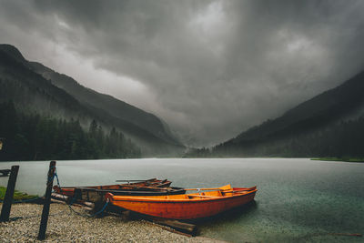 Boats in lake against mountains