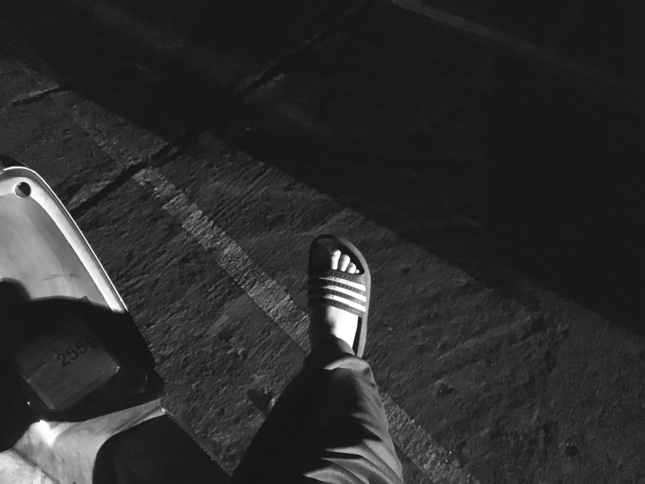 low section, person, personal perspective, lifestyles, shoe, high angle view, leisure activity, men, unrecognizable person, standing, human foot, part of, shadow, footwear, street, sunlight