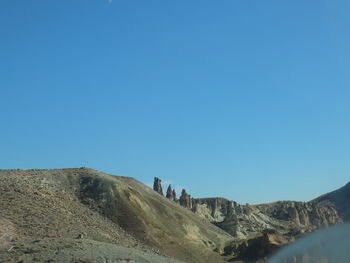 Scenic view of mountains against clear blue sky