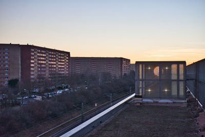 Buildings in city against sky during sunset