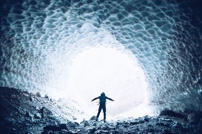 Rear view of a man standing in tunnel