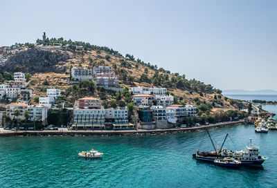 Summer mediterranean views of the boats, cityscape, water, sky from the port of kusadasi, turkey