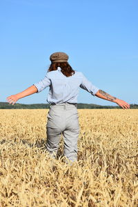 Man standing on field against clear sky