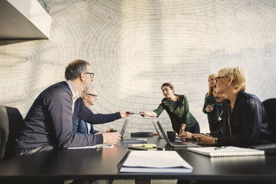 Multi-ethnic business people discussing at table in creative office