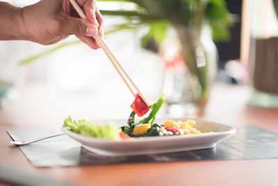 Midsection of person having food in bowl