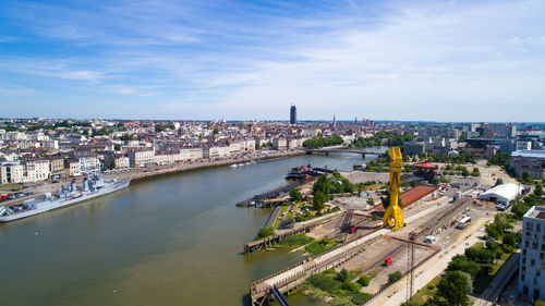 High angle view of river amidst cityscape against sky
