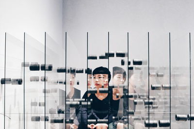 Portrait of young man standing against reflection of sky