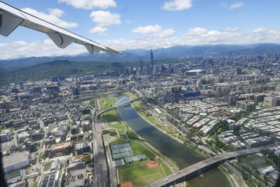 Aerial view of city and buildings against sky