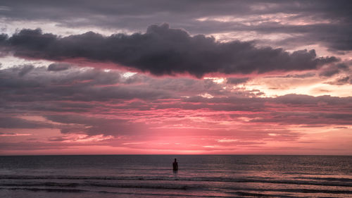 Scenic view of sea against dramatic sky